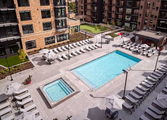 an aerial view of a swimming pool and poolside lounge chairs at an apartment building at Expo, Minnesota