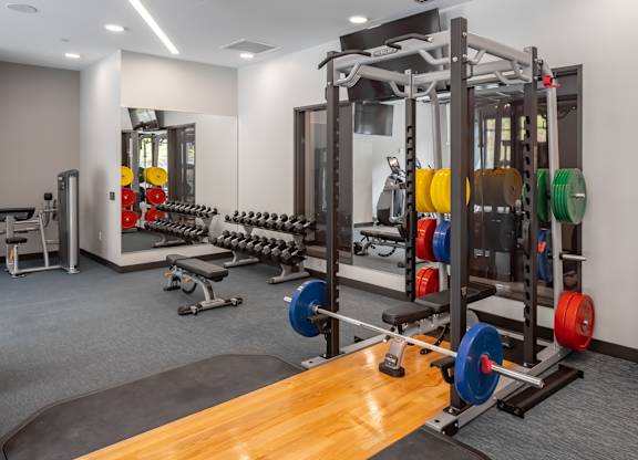 a gym with weights and other exercise equipment on a wooden floor at Expo, Minneapolis, MN