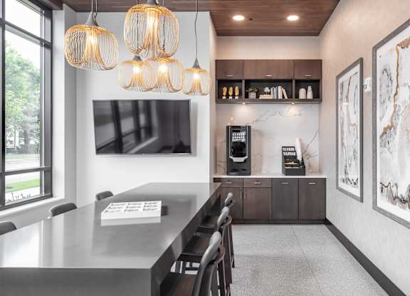 a kitchen with a long table and chairs and a large window at Expo, Minnesota