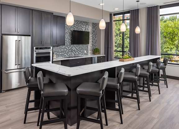 a kitchen with a large island with bar stools at Expo, Minneapolis