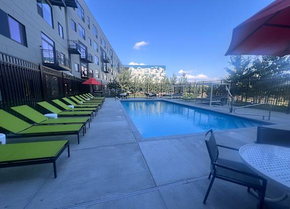 A pool area with sun loungers and a table.