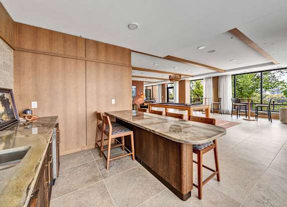 A kitchen with a wooden island and chairs.at Lilia, Lilydale, Minnesota