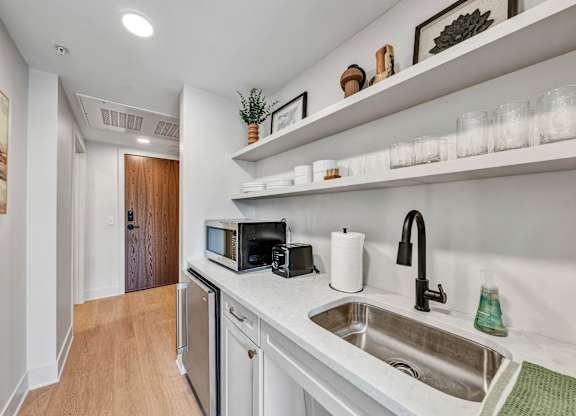 A kitchen with a sink, microwave, and dishwasher.at Lilia, Minnesota