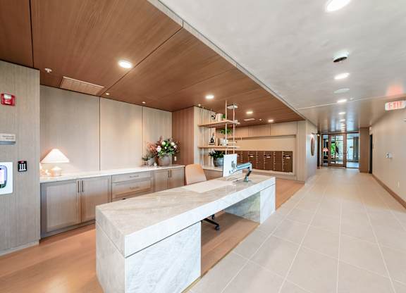 A reception area with a marble counter and a wooden ceiling.at Lilia, Minnesota, 55118