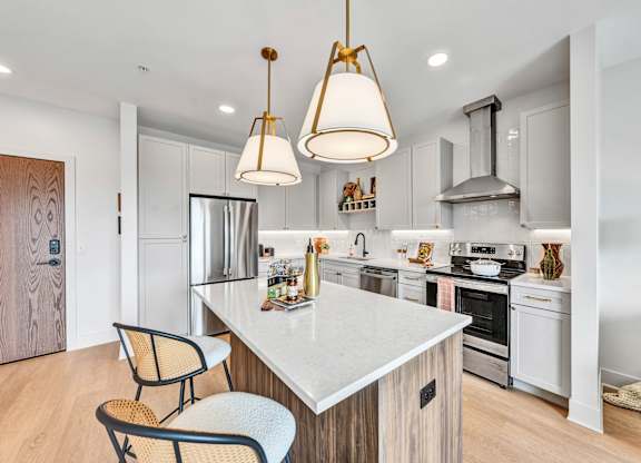 A modern kitchen with a white countertop and a large island.at Lilia, Minnesota, 55118