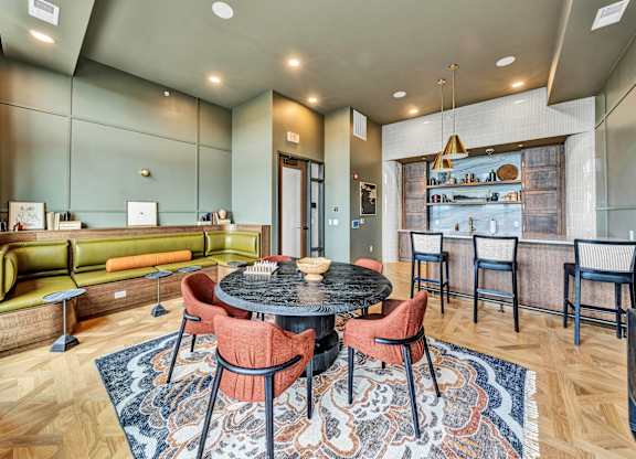 A modern dining room with a round table and chairs.at Lilia, Lilydale, MN