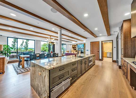 A modern kitchen with wooden cabinets and a large island.at Lilia, Lilydale, Minnesota