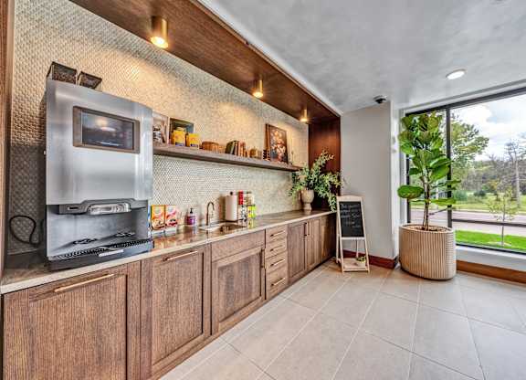 A kitchen with wooden cabinets and a microwave oven.at Lilia, Lilydale, Minnesota