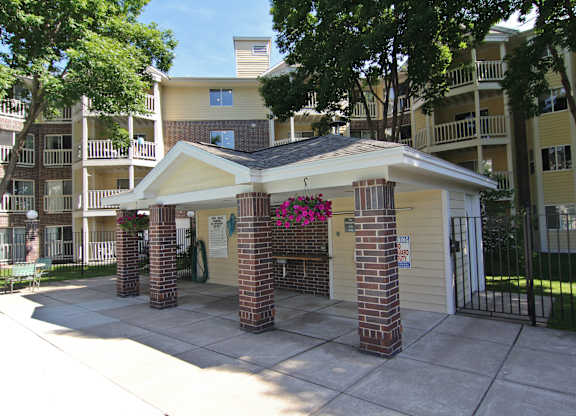 an outside view of an apartment building with a driveway and a gate at Cityscape, St Louis Park, 55416