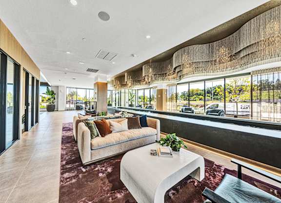 Lobby with seating, table, and water feature at The Mera, St Louis Park, MN, 55426