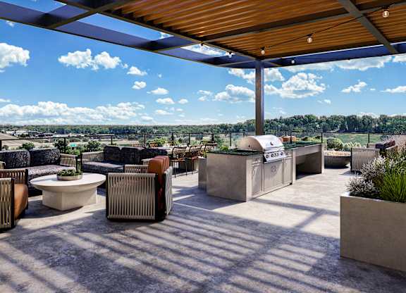 a patio with furniture and a grill and a roof at The Mera, St Louis Park Minnesota