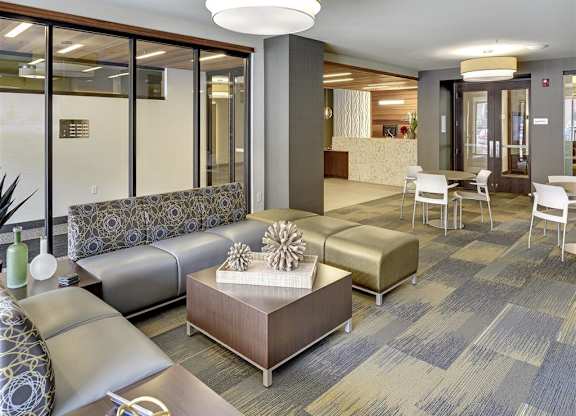 Be @ Axon Green Lounge Area with couches, chairs, and coffee table