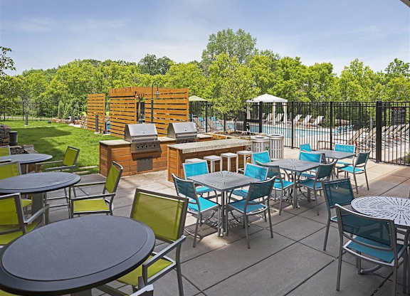Be @ Axon Green  Outdoor Sitting Area with blue and green chairs and steel tables