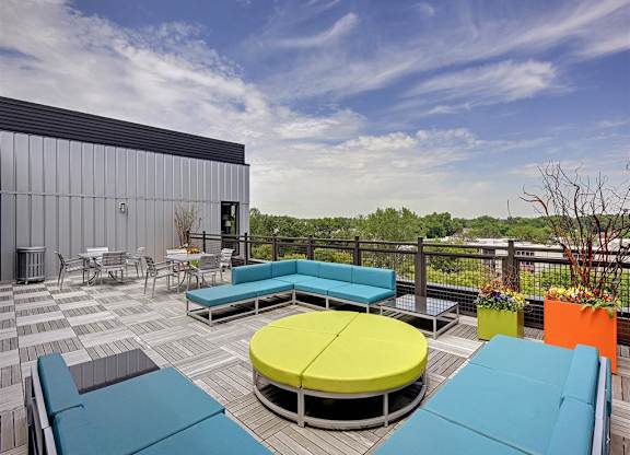 Be @ Axon Green Rooftop Patio and Sitting Area with couches, chairs, and tables