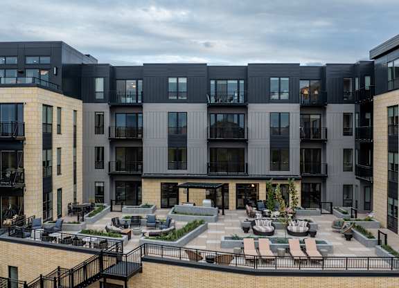 A modern apartment complex with a central courtyard.at Lilia, Lilydale, MN