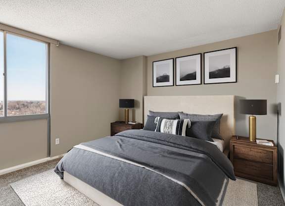 a bedroom with a large window and a large bed at The Edina Towers, Edina, MN