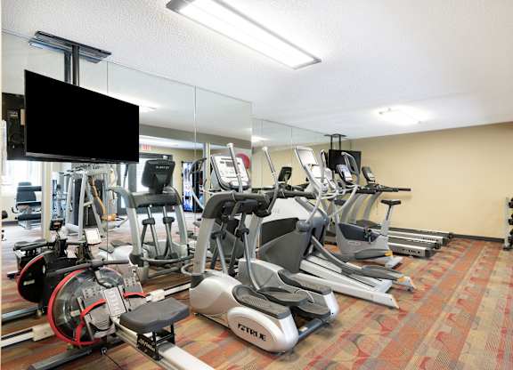 a room filled with cardio equipment and a flat screen tv at MacLaren Hill, St. Paul, MN, 55108