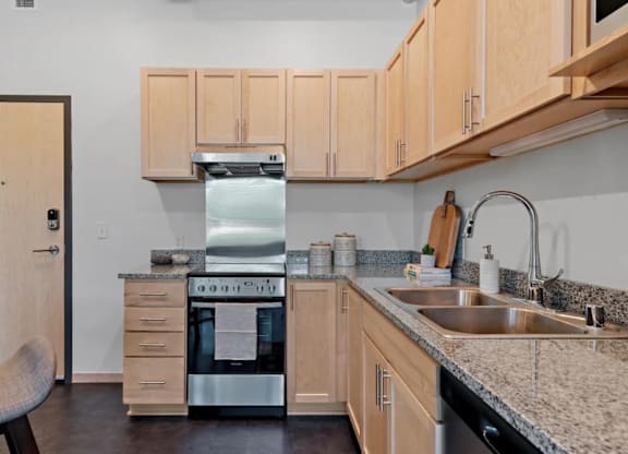 a kitchen with granite counter tops and a sink at Zelia on Seven, Minnesota, 55416