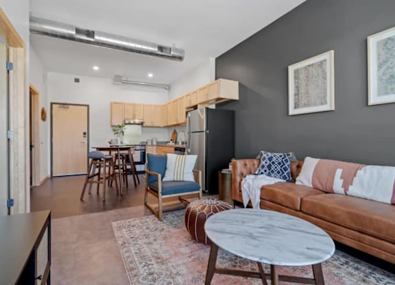 a living room and kitchen with a couch and a table at Zelia on Seven, Minnesota