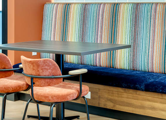 Two chairs are placed in front of a table.