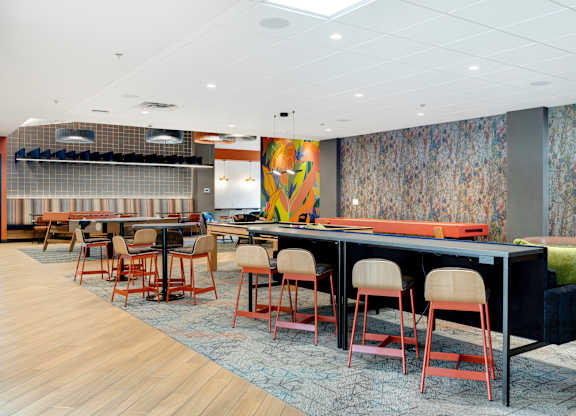 A room with a long table and chairs.