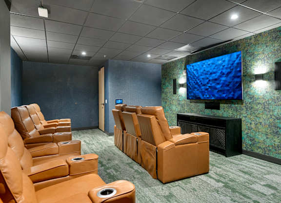 Zelia on Seven theater room with brown leather reclining chairs