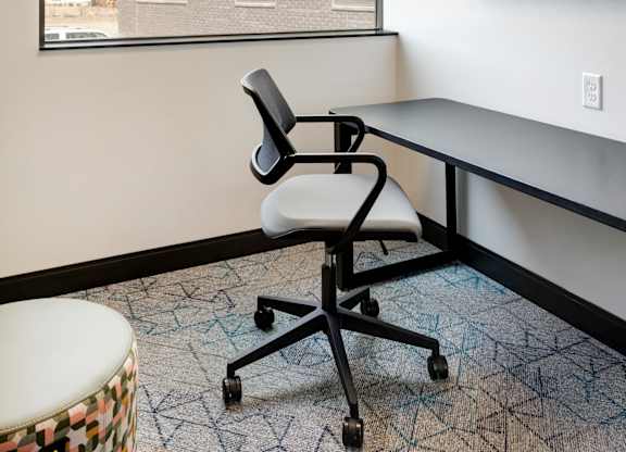 Work from home space with a desk, chair and a painting on the wall.