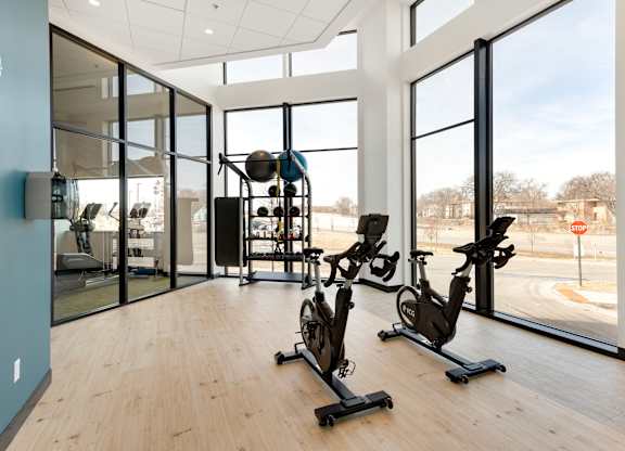 spin room with bikes and weight rack