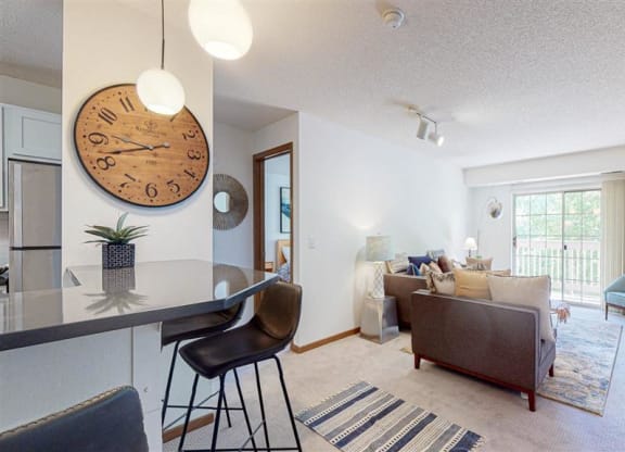 a living room with a stool and couch