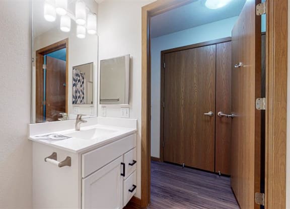 a bathroom vanity with mirror and sink