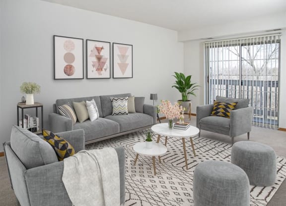 a living room with couches and chairs and a rug