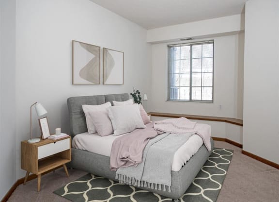 a bedroom with a bed and a window