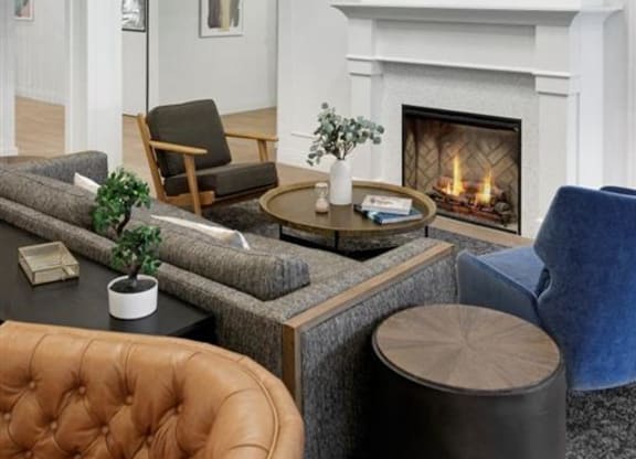 a shared common area with couches and chairs and a balcony