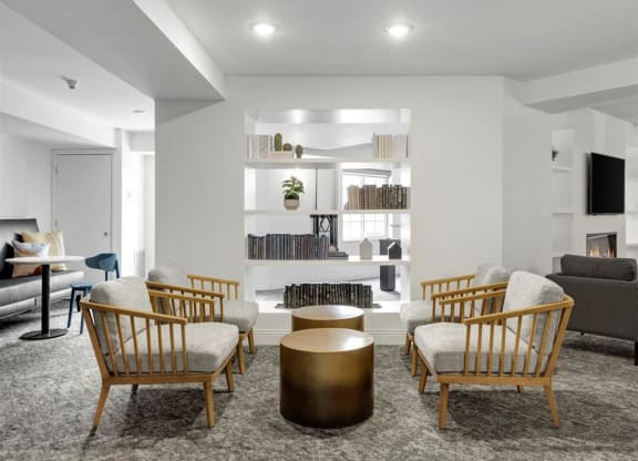 a living room with chairs and a table