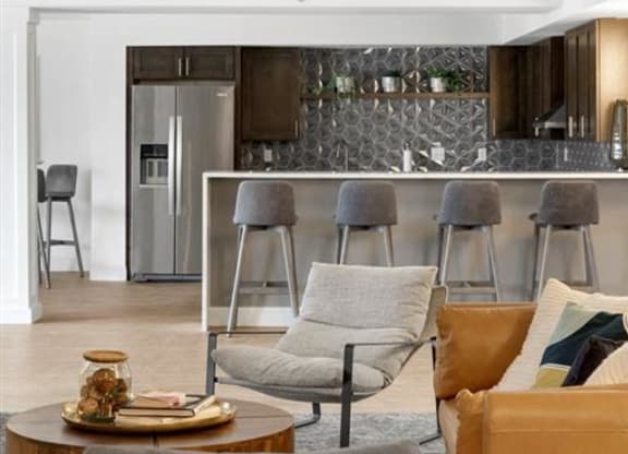 a shared community room with a table and chairs and a kitchen