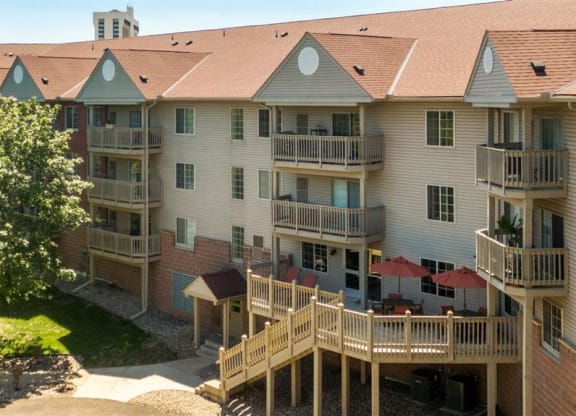 an aerial view of an apartment building with balconies and a tree