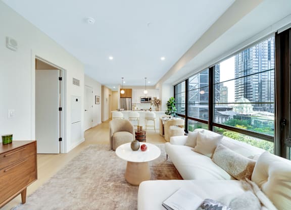A modern living room with a white couch and a coffee table.