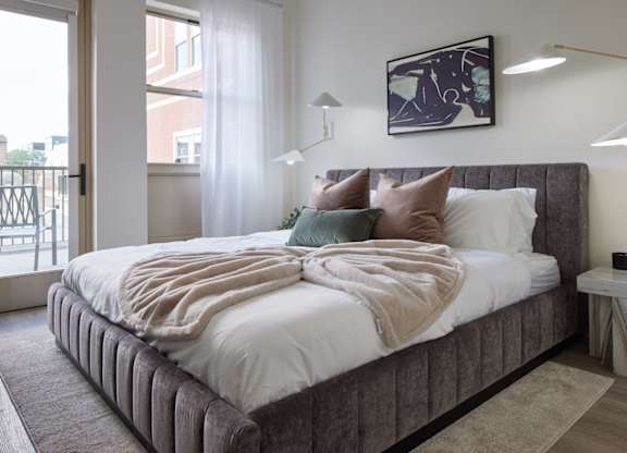 a bedroom with a large bed and a window