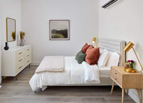 a bedroom with a bed and a dresser