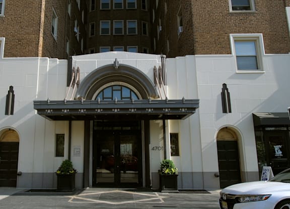 A building with a large arched entrance and a sign that reads