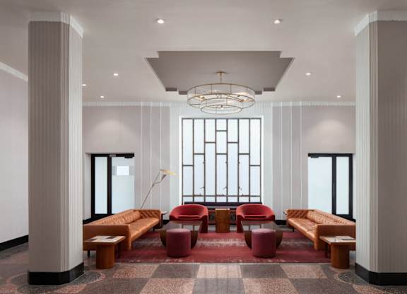 A large room with a long table and chairs in the middle.