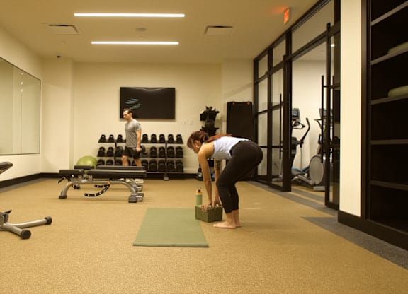 A gym with a person doing a yoga pose.