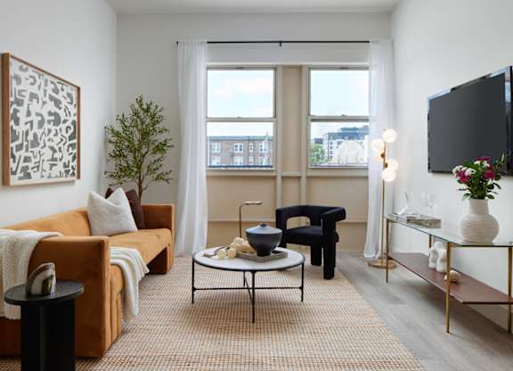 a living room with a couch and a table and a television