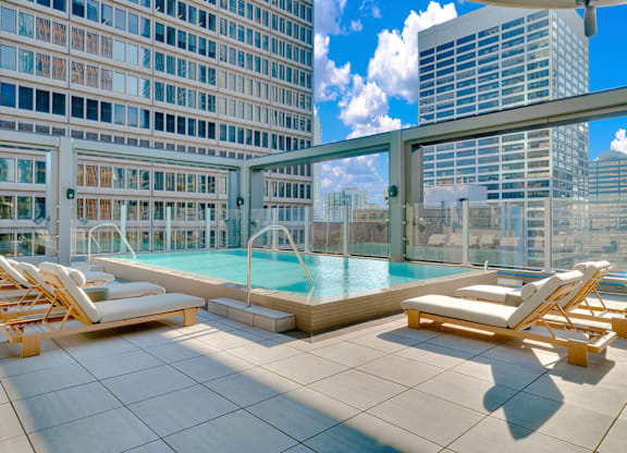 A pool surrounded by chairs on a patio. at 17 Market West, Philadelphia Pennsylvania