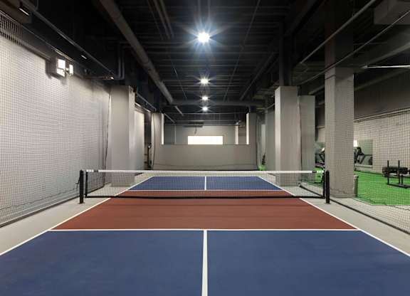 A tennis court with a net and two benches. at 17 Market West, Pennsylvania