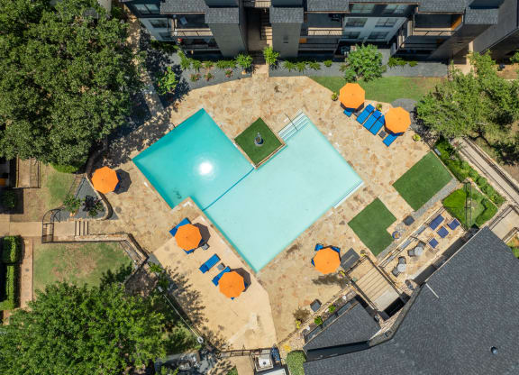 arial view of a pool and tennis court with orange umbrellas and trees at District 2308, Texas, 76011