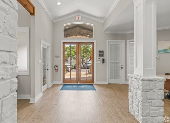 the entrance to the home has a stone wall and wood floors at District 2308, Arlington, TX ?