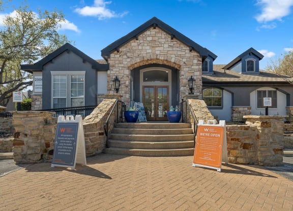 the front of a house with steps and a sign in front at District 2308, Texas 