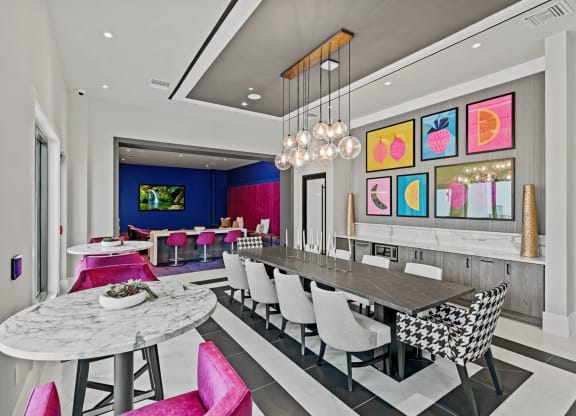 a dining room with a long table and chairs at Altis Grand Kendall, Florida