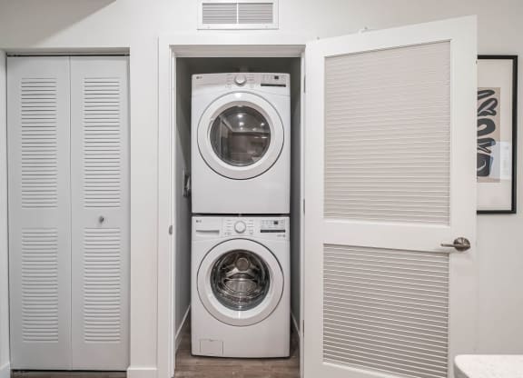 a small laundry room with a washing machine and a dryer at Altis Grand Kendall, Miami, 33186